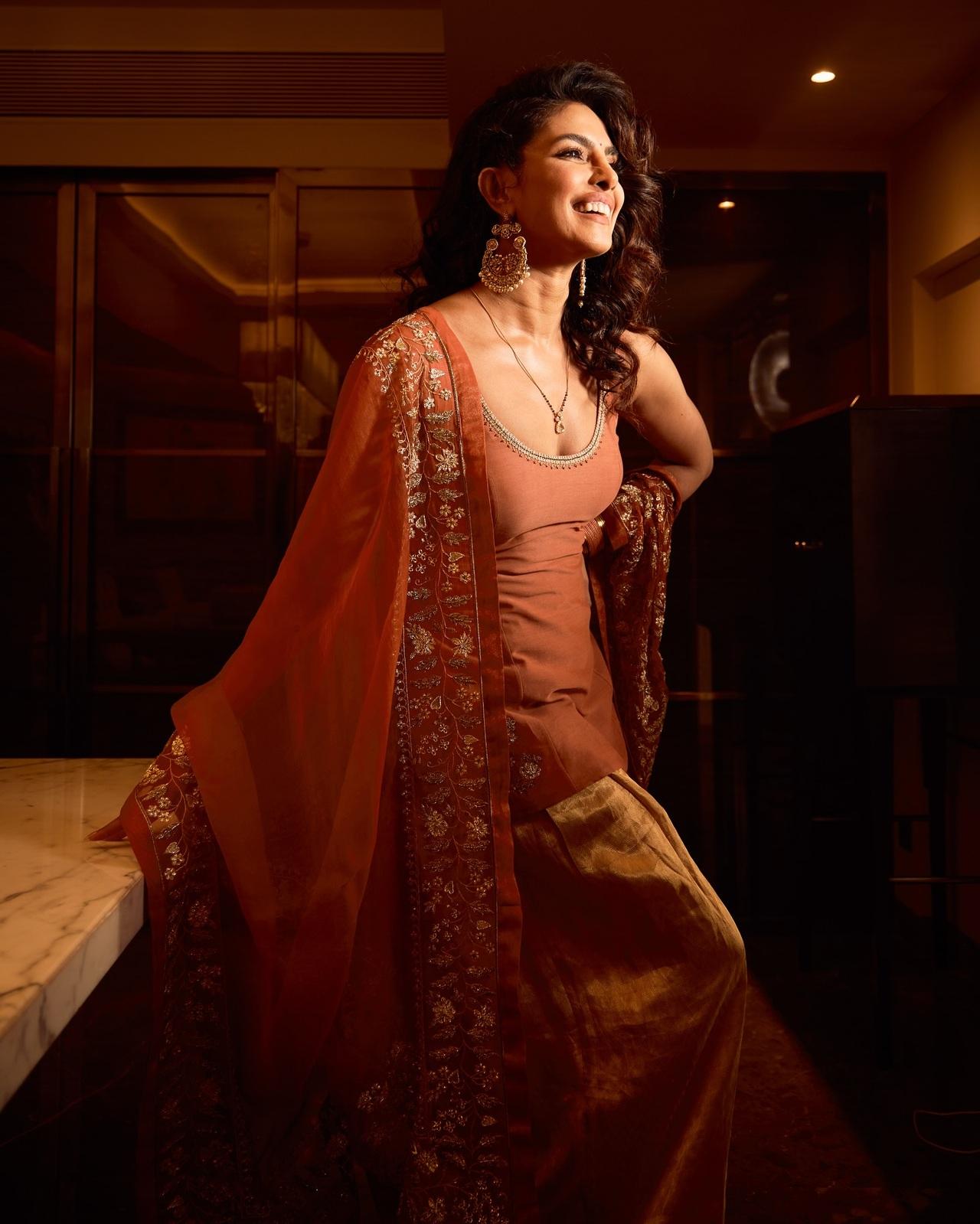 For an elegant and sleek look, Priyanka curled her hair and secured them neatly at one side. This look does not require heavy hair accessory and is perfect for celebrations.